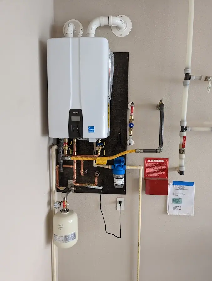 Professional plumber installing copper piping in a Macclenny home